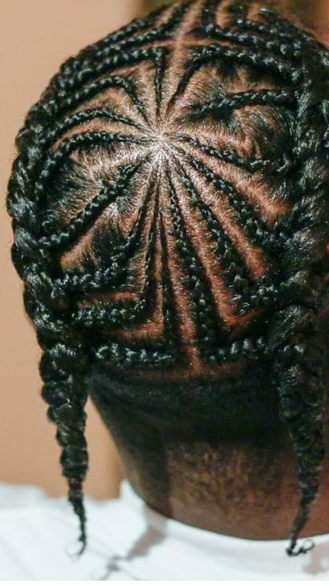 A man with braids in his hair, exemplifying a trendy braid hairstyle that highlights his unique style.