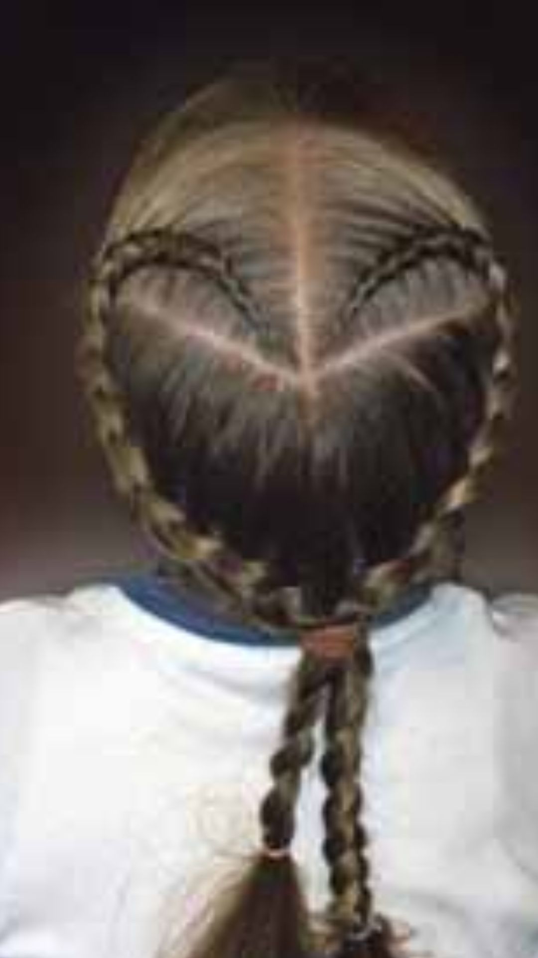 A young girl with intricate braids, highlighting a fashionable and youthful hairstyle.