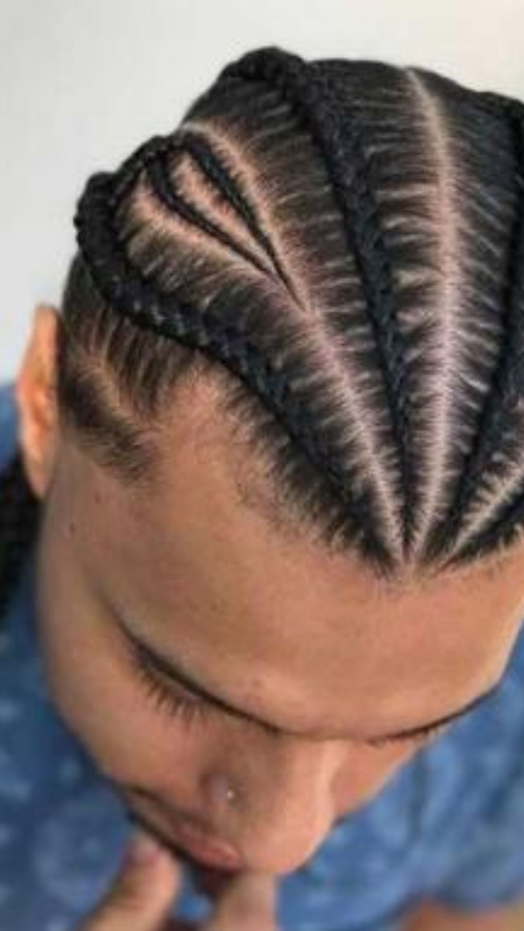 A man showcasing a stylish braid in his hair, highlighting the elegance of braid hairstyles.