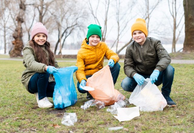 Kids playing their role in waste management by cleaning the surroundings