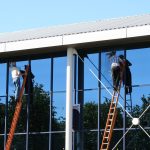 753733 – two window cleaners at work on office building